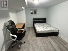 Toronto (L'amoreaux) apartment for rent - A bedroom with a bed, desk, and chair.