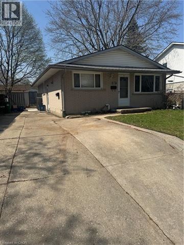 Kitchener apartment for rent - A house with a grey roof and a white door is shown.