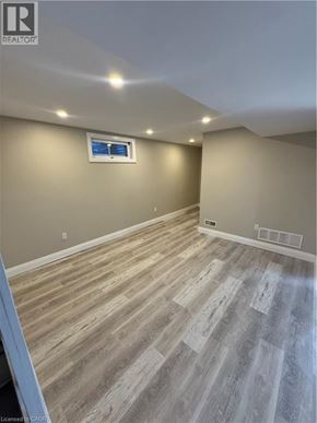 Kitchener apartment for rent - A room with wooden flooring and a window.