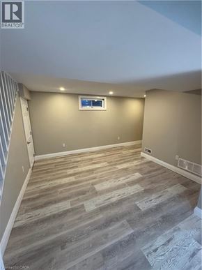 Kitchener apartment for rent - A room with wooden flooring and a window.