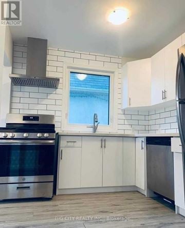 Toronto (Rockcliffe-Smythe) apartment for rent - A kitchen with white cabinets and a stainless steel oven.