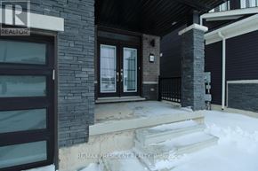 Thorold (Rolling Meadows) apartment for rent - A house with a black door and windows is covered in snow.