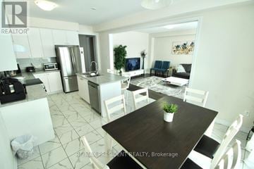 Thorold (Rolling Meadows) apartment for rent - A modern kitchen with a dining table set for four.