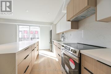 Toronto (Dufferin Grove) apartment for rent - A modern kitchen with wooden cabinets and a stove top oven.