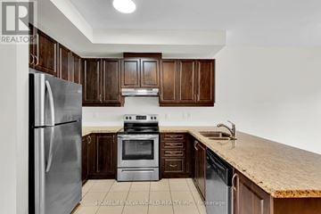Brampton (Heart Lake East) townhouse for rent - A kitchen with wooden cabinets and a stainless steel refrigerator.
