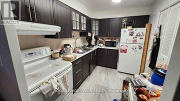 Toronto (Flemingdon Park) condo for rent - A kitchen with a white stove top oven and a white refrigerator.