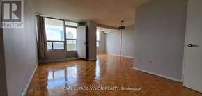 Toronto (Flemingdon Park) condo for rent - A large, empty room with wooden floors and white walls.