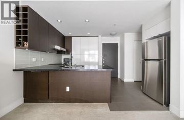 Vancouver apartment for rent - A modern kitchen with dark brown cabinets and stainless steel appliances.