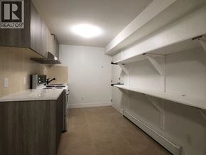 Burnaby apartment for rent - A kitchen with a counter and a refrigerator.
