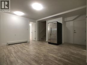Burnaby apartment for rent - A spacious room with a refrigerator in the corner.