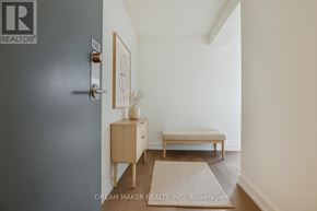 Toronto (Birchcliffe-Cliffside) townhouse for rent - A brokerage logo is on the door of a room with a bed and a table.