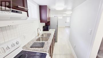 Oshawa (O'neill) apartment for rent - A kitchen with white appliances and a granite counter top.