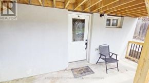 Oshawa (O'neill) apartment for rent - A room with a chair and a door.