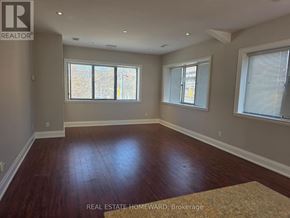 Toronto (Moss Park) apartment for rent - A room with wood flooring and two windows.