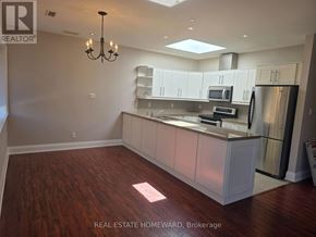 Toronto (Moss Park) apartment for rent - A well-lit kitchen with a dining area and a chandelier.