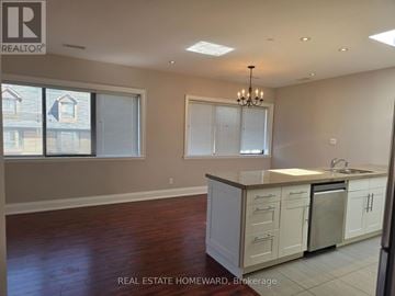 Toronto (Moss Park) apartment for rent - A kitchen with white cabinets and a wooden floor.