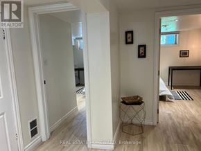 Toronto (Woburn) apartment for rent - A hallway with a basket on a table and pictures on the wall.