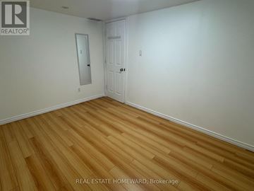 Toronto (Wexford-Maryvale) apartment for rent - A room with wooden flooring and a white door.