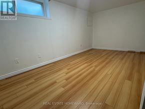Toronto (Wexford-Maryvale) apartment for rent - A room with wooden flooring and a window.