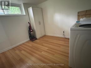 Toronto (Wexford-Maryvale) apartment for rent - A room with a washing machine and a vacuum cleaner.