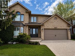 Burlington apartment for rent - A house with a garage and a driveway in front.
