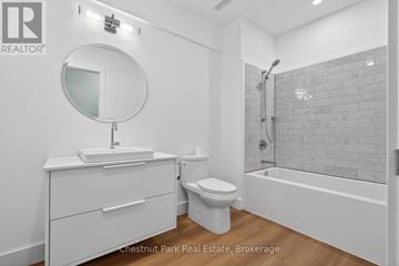 Huntsville (Chaffey) apartment for rent - A white bathroom with a round mirror and a white toilet.