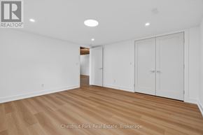 Huntsville (Chaffey) apartment for rent - A room with white walls and wooden flooring, with a logo in the top left corner that reads "REALTOR".