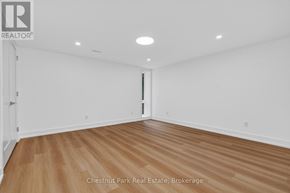 Huntsville (Chaffey) apartment for rent - A room with wood flooring and white walls, with a door on the right side.