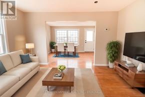 Welland (N. Welland) apartment for rent - A living room with a white sofa, a wooden coffee table, and a flat screen TV.