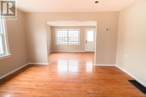 Welland (N. Welland) apartment for rent - A room with wooden floors and a window with blinds.