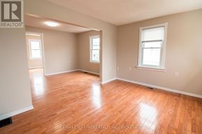 Welland (N. Welland) apartment for rent - A room with wooden floors and two windows.