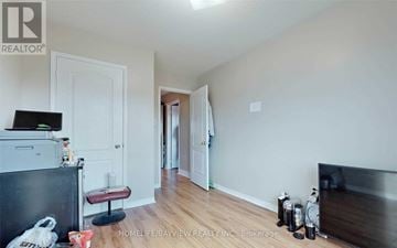 Vaughan (Concord) townhouse for rent - A living room with a black couch and a white wall.
