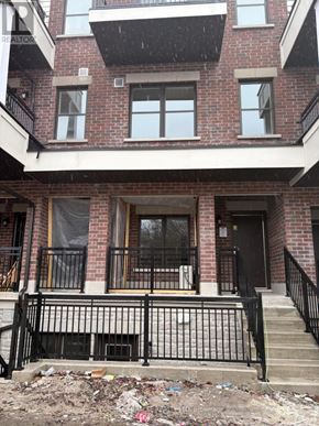 Aurora (Aurora Village) townhouse for rent - A red brick building with a black iron fence in front.