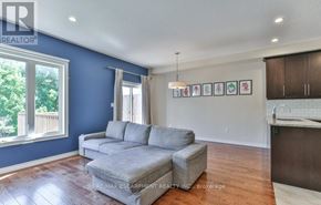 London North (North B) townhouse for rent - A living room with a grey sofa and a wooden floor.