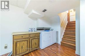 Toronto (Steeles) apartment for rent - A wooden cabinet with a white countertop is in a room with a staircase.