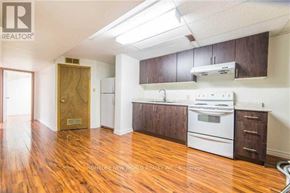 Toronto (Steeles) apartment for rent - A kitchen with wooden floors and white appliances.