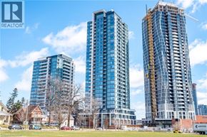 Kitchener condo for rent - Three high-rise buildings are under construction in a city setting.