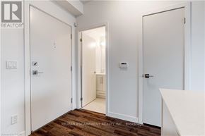 Burlington (Freeman) condo for rent - A white door with a black handle is in a room with a wooden floor.