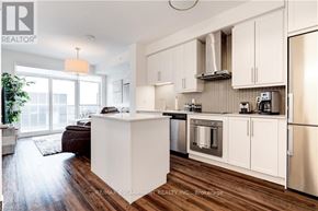Burlington (Freeman) condo for rent - A modern kitchen with white cabinets and stainless steel appliances.