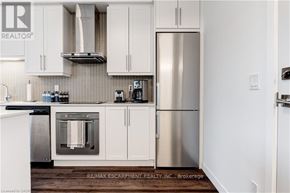 Burlington (Freeman) condo for rent - A kitchen with white cabinets and a stainless steel refrigerator.