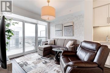 Burlington (Freeman) condo for rent - A living room with a brown leather couch and a grey sofa.