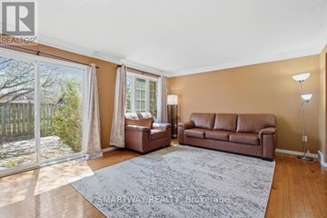 London East (East A) apartment for rent - A living room with a brown couch and a grey rug.