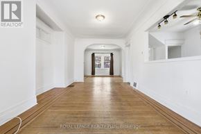 Hamilton (Crown Point) apartment for rent - A long, empty hallway with wooden floors and white walls.