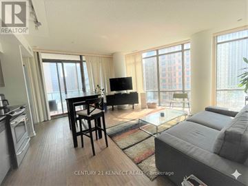 Toronto (Bay Street Corridor) condo for rent - A living room with a grey couch and a glass table.