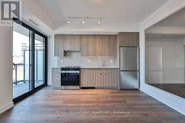 Burlington (Brant) house for rent - A modern kitchen with wooden cabinets and stainless steel appliances.