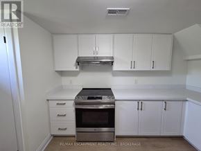 St. Catharines (Secord Woods) apartment for rent - A kitchen with white cabinets and a stainless steel oven.
