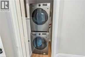 Hamilton apartment for rent - A washer and dryer stacked on top of each other in a small laundry room.