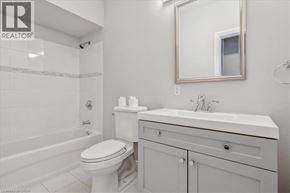 Hamilton apartment for rent - A white bathroom with a toilet, sink and bathtub.
