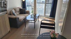 Toronto (Waterfront Communities) condo for rent - A living room with a couch, chair, and a coffee table.