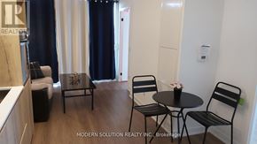 Toronto (Waterfront Communities) condo for rent - A brokerage office with a table and chairs.